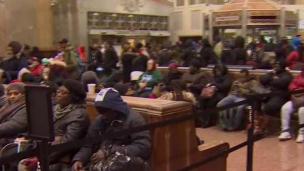 Transit commuters wait for a stormy return home